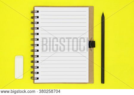 Back To School. Educational Concept, Office Supplies. Craft Notepad, Black Pencil And White Eraser O