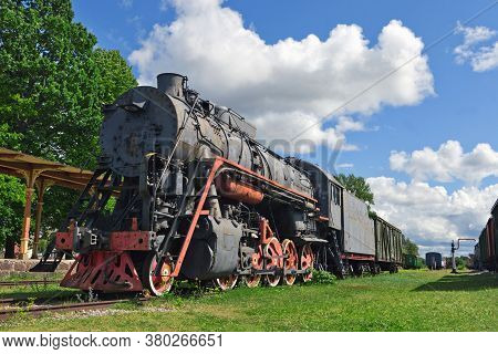 Railway Museum In The Town Of Haapsalu. In The Foreground Is The Old Locomotive And The Train Statio