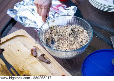 Person Serving Themselves A Spoonful Of Brazilian Farofa Or Pacoca Nordestina At Dinner.