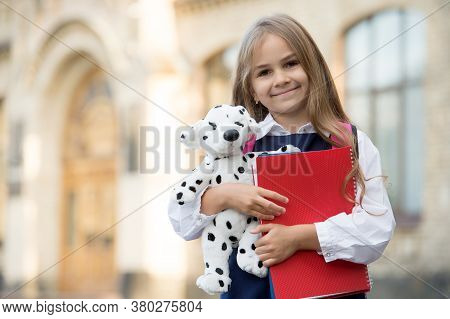 Learn And Play. Happy Child Hold Toy Dog And Books. Back To School. Primary Education. Creativity An