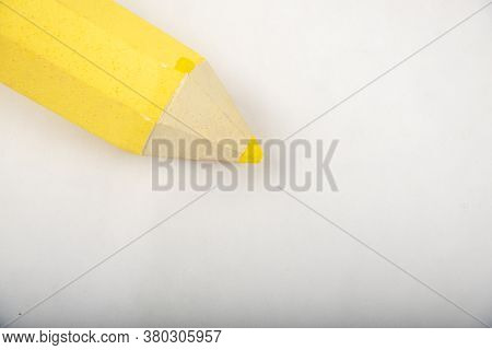 Yellow Pencil Stands On A White Background.