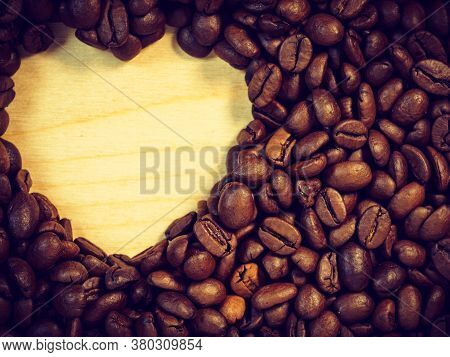 Roasted Brown Coffee Beans With Empty Heart Form Shape.
