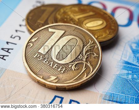 Russian Coins Of 10 Rubles Are On A Russian Banknote Of 2000 Rubles. Close-up