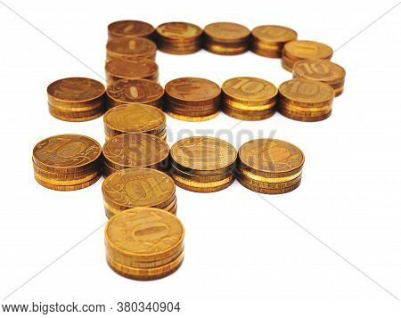 The Sign Of The Russian Ruble, Laid Out In Stacks Of Coins Of 10 Rubles. The Background Is White, No
