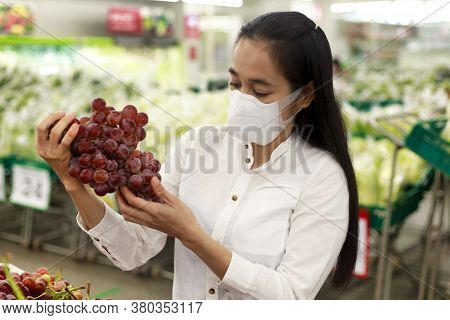 Women Looking Clothes In Shopping Mall. Asian Women Smileing Happy To Choice And Tried Clothes In Sh