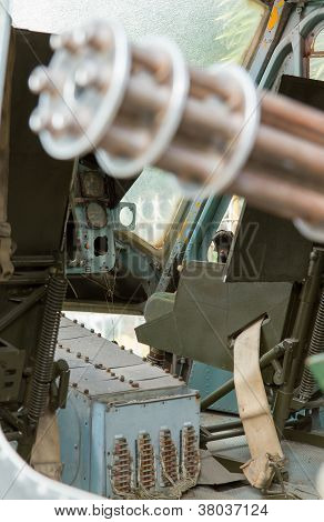 Chaingun In An Old American Helicopter Used In The Vietnam War,focus On The Pilot Area