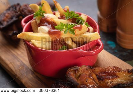 Canadian poutine, fried potato chips with cheese and gravy or sauce