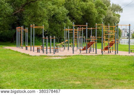 An Empty Playground With Horizontal Bars, Crossbeams And Parallel Bars. Outdoor Sports In Nature In 