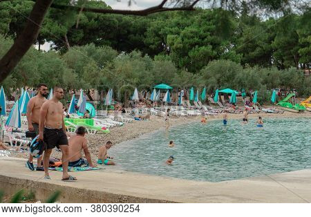 Supetar, Croatia August 2020 Famous Beach In The Town Of Supetar, Filled With People Swimming On A W