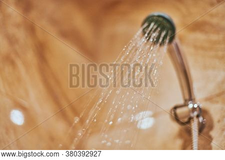Showerhead In Bathroom. Shower Head With Blurred Hot Water Drops. Take A Fresh Contrast Shower For S