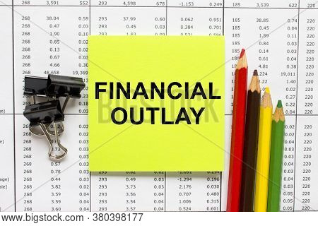 Text Financial Outlay On Financial Tables With Pencils, Glasses And Paper Clips