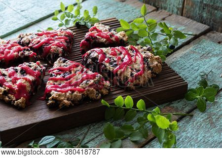 Blueberry Cutted Scones On Oak Cutboard With Blueberry Leaves With Old Painted Wood Close Up