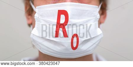 R Nought Theme With Person Wearing A Protective Surgical Face Mask
