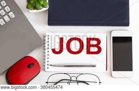 Laptop, Pen And Notepad With Text Job In The White Background With Office Tools