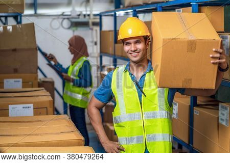 Idian Worker Man Holding Cardboard Box And Walking With Muslim Worker Woman Scanning Bar Code And Qr