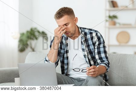 Fatigue From Work. Tired Guy Feeling Eyestrain, Holding Specs, Rubbing Dry Irritated Eyes, Massaging