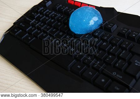 Blue Soft Gel Cleaning Dust On Keyboard. Concept Cleaning Your Computers Keyboard.