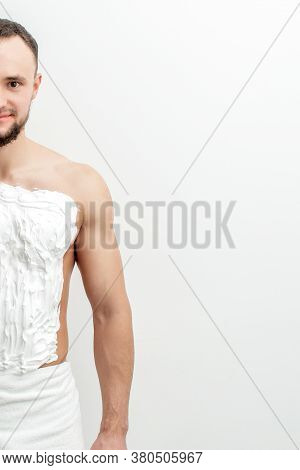 Young Caucasian Man With Beard Holds Razor Shaves His Chest With White Shaving Foam On White Backgro