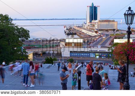 Odessa, Ukraine - August 4, 2020: view of the seaport and Potemkin stairs near the Primorskiy boulevard, walking people