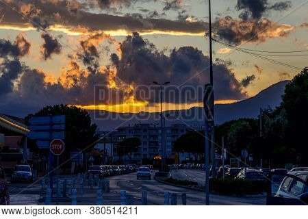 Cagnes-sur-mer, France 03.08.2020 Golden And Dark Clouds In The Evening City. Heavenly Dreamy Fluffy