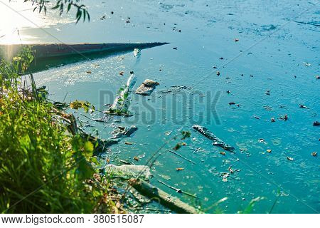 Environmental Water Pollution. Polluted River - Dirty Green Water, Garbage, Waste And Trash. Harmful