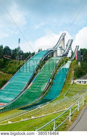 Lahti, Finland - 4 August 2020: Lahti Sports Centre With Three Ski Jump Towers. Sportsman Is Jumping