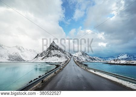 Olstind Mount and asphalt road. Lofoten islands, spring time, Norway