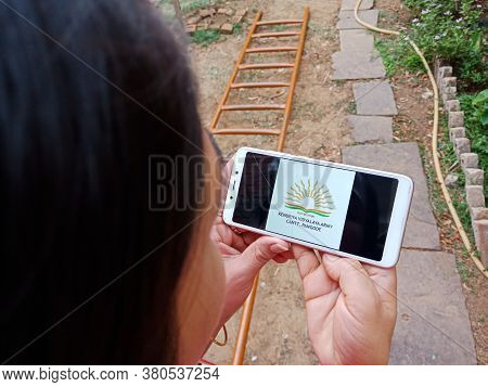 District Katni, India - 28 May 2020: An Indian Lady Holding Smart Phone With Displaying Kendriya Vid