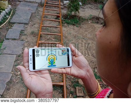 District Katni, India - 28 May 2020: An Indian Lady Holding Smart Phone With Displaying Internationa