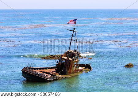 August 3, 2020 In Cayucos, Ca:  Rustic Half Sunken Fishing Vessel Offshore Cayucos, Ca Where People 