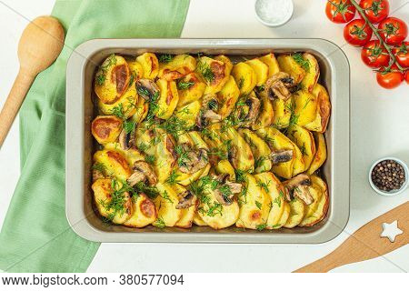 Potato Wedges Baked With Mushrooms, Herb Oven Roasted, With Thyme, A Close-up In A Baking Tray. Top 
