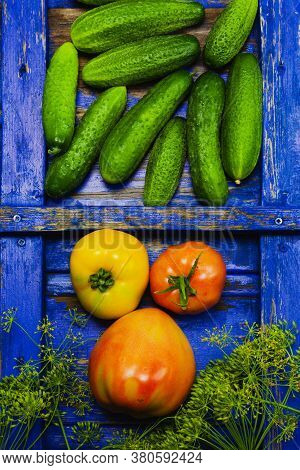 Cucumber Tomato And Dill, Fresh Vegetables On The Background Of A Wooden Blue Retro Texture.