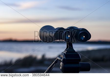 Binocular lens with a beautiful abstract blurred background, can be used for business vision or business prediction concept
