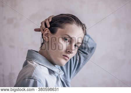 Tomboy Straightens His Hair. Tomboy In A Denim Jacket