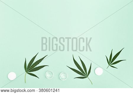 Jar With Transparent Cosmetic Product, Gel Or Cream With Cannabis Oil On Green Colored Background. F