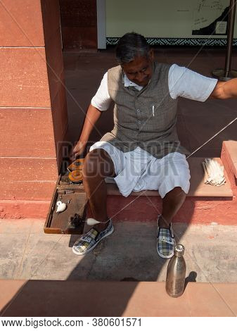 Delhi, India - March 15, 2019: A Man Spins Thread With A Replica Folding Spinning Wheel Of The Type 