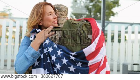 Happy Young Caucasian Couple Meeting And Hugging At Street. Handsome Male Soldier In Uniform Coming 