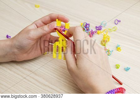 Rubber Band Weaving. Knitting Rubber Bands With Loom Knit. Hands Of Girl Weaving Wristband Of Rubber