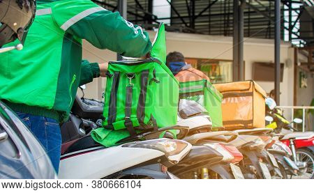 The Food Delivery Driver Is Preparing The Product To Deliver To The Customer According To The Online