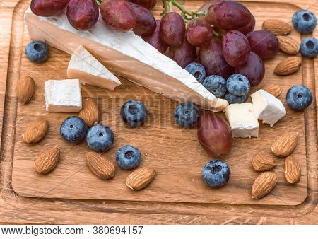Set Of Elite Delicious Food, Brie Cheese, Grape, Migdal And Blueberry