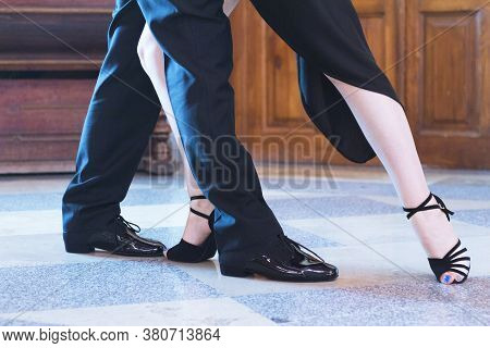 Legs Of Man And Woman Dancing Argentine Tango. Black Shoes