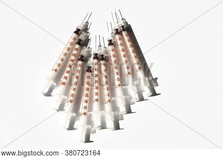 Medical Syringe From Diabetic Therapy. Clouse Up Of Syringe On White And Blue Background