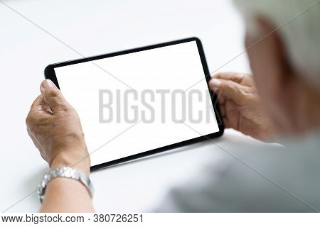Elderly Senior Hand Using Tablet Computer With Empty Screen