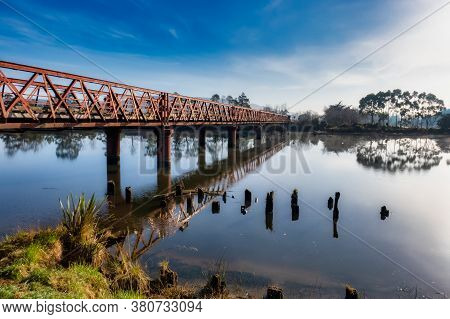 Historic Henley Suspension Bridge Over The River Taieri At Otokai In The Early Morning