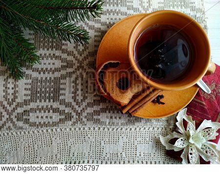 Christmas Tea On Linen Tablecloth In The Shaffron Colored Cup.