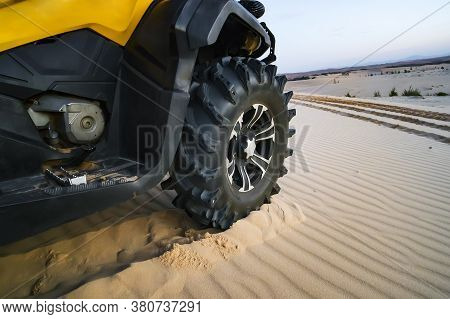 Off-road Atv Car Closeup Detail Big Tire, Unrecognizable. Atv Wheel Close Up. Tourist On The Quad Bi