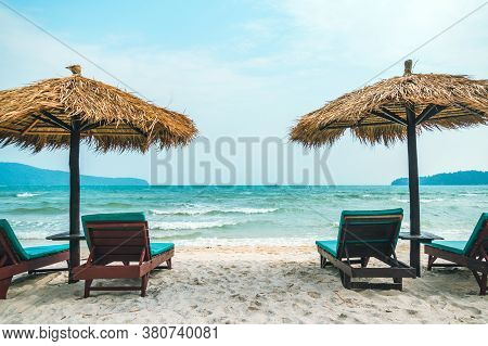 Sun Bed On The Beach Under The Straw Sunshade. Coast Of Island Koh Rong Samloem, Cambodia. A Sad Des