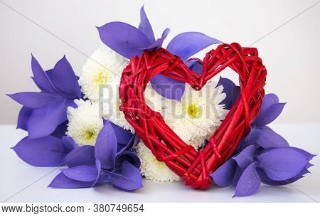 Concept Of Valentine's Day And Women's Day. Wicker Heart With An Unusual Bouquet Of Chrysanthemums O