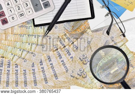 25 Egyptian Piastres Bills And Calculator With Glasses And Pen. Tax Payment Season Concept Or Invest