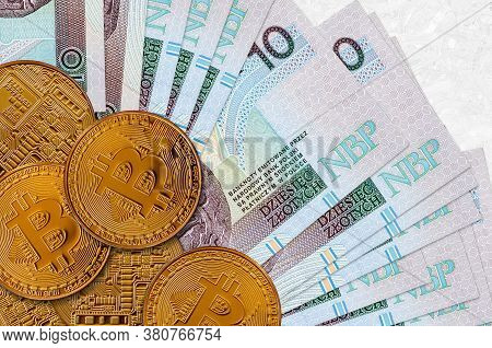 10 Polish Zloty Bills And Golden Bitcoins. Cryptocurrency Investment Concept. Crypto Mining Or Tradi